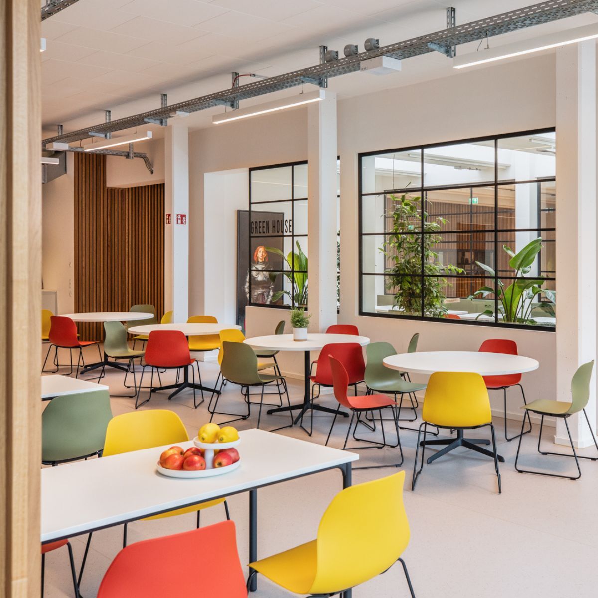 Blick über verschiedene Bereiche der Cafeteria der Frankfurt International School, geplant und eingerichtet von designfunktion