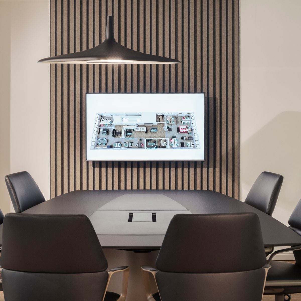 Konferenztisch mit Stühlen und Bildschirm im neuen Schauraum von designfunktion in München